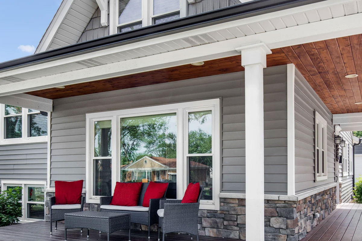Outdoor seating area with red cushions on a porch