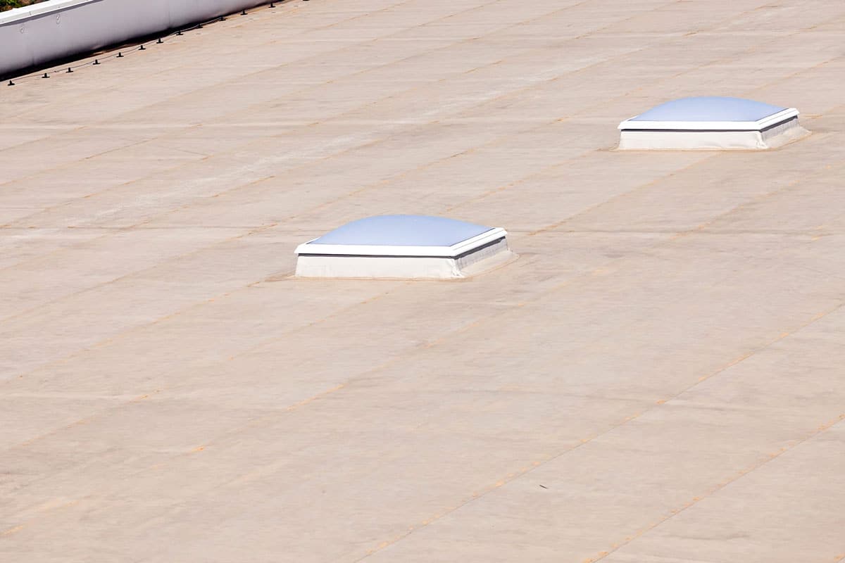 Flat roof with two small skylights installed