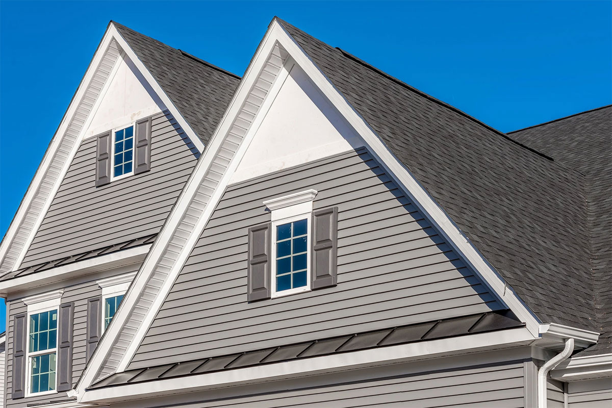 Gray house with white trim. The house features a dark roof.
