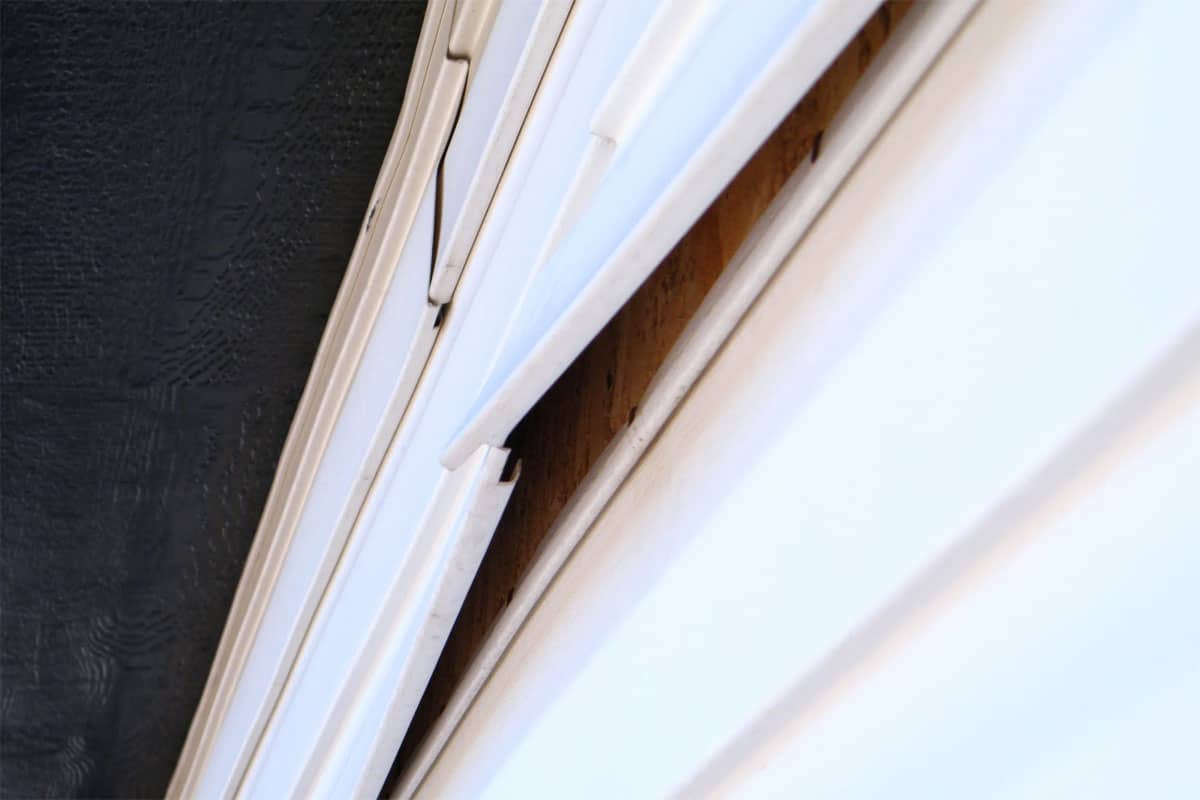 A white window blind with a small gap