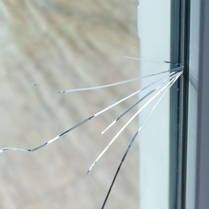 Cracked glass in window. Broken window pane.