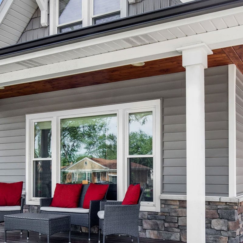Outdoor seating area with red cushions on a porch